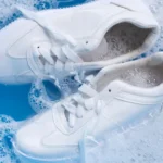 Um par de tenis branco sobre agua com sabão